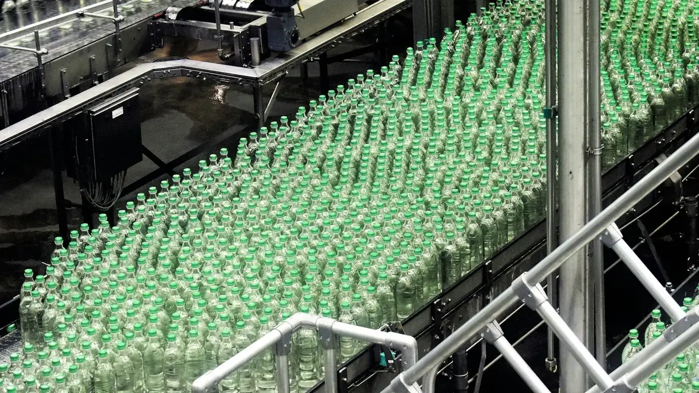 Green bottles moving on a bottling line