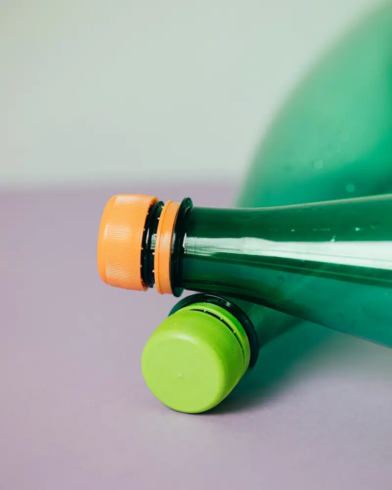Green PET bottle with a coloured cap